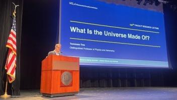 Professor Tommaso Treu presenting PowerPoint at podium