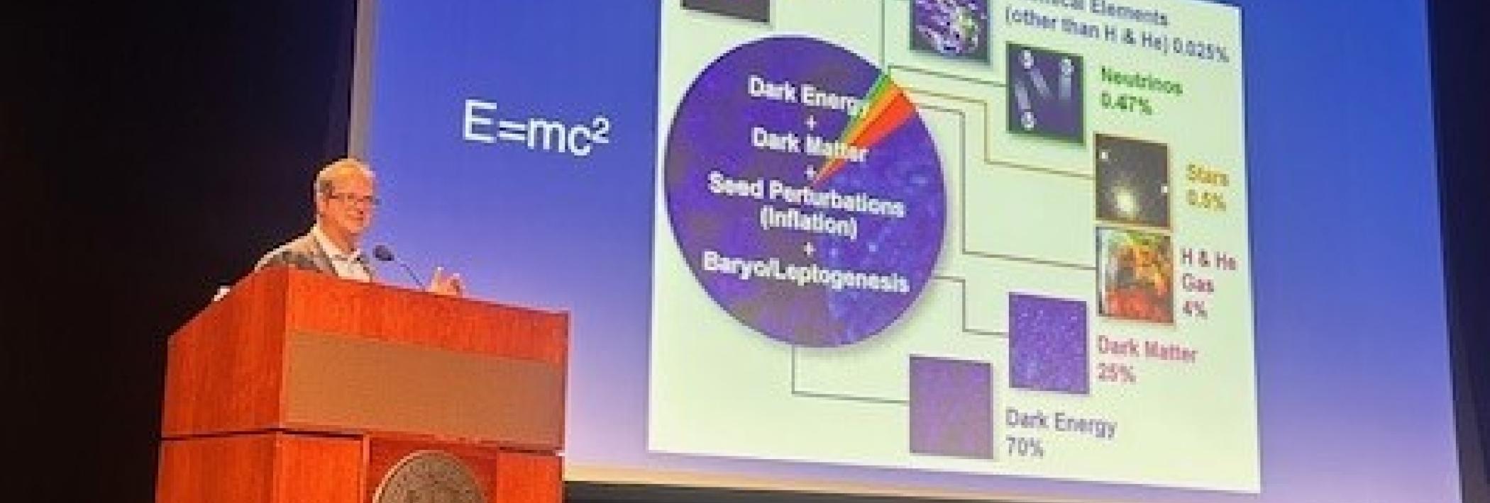 Professor Tommaso Treu presenting at podium